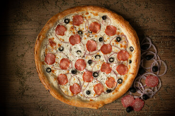delicious chicken pizza with sausages and mushroom. dark wooden table background