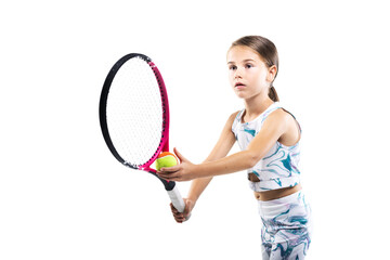 Young female tennis player. Little girl posing with racket and ball isolated on white background.