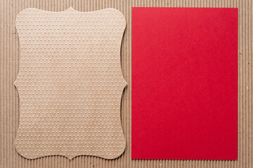 textured brown envelope liner with elegant contours and smooth red paper card on corrugated texture