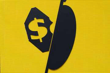 dollar sign stencil cutout on grungy yellow corrugated paper