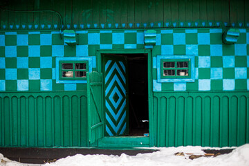 Krasnoilsk, Ukraine - 13 Jan 2017: green and blue traditional wall of a house in a Ukrainian village