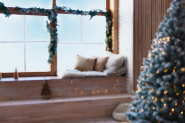 Obraz na płótnie Canvas Blurred view of room with Christmas tree and festive decor