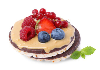 Crunchy rice cakes with peanut butter and sweet berries isolated on white