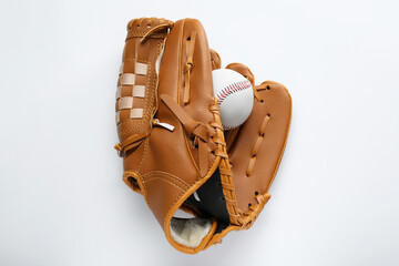Catcher's mitt and baseball ball on white background, top view. Sports game