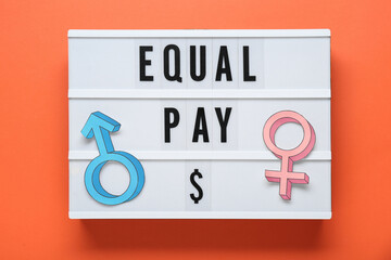 Equal pay. Lightbox and paper gender symbols on orange background, top view