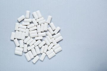 Tasty white chewing gums on light grey background, flat lay. Space for text