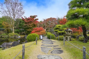 青空バックに見るカラフルな紅葉に包まれた日本庭園の情景＠兵庫
