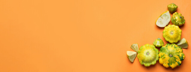 Naklejka na ściany i meble Fresh pattypan squashes on orange background, flat lay with space for text. Banner design