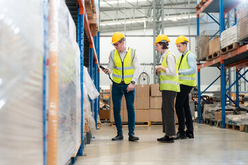 Warehouse team discussing while walking in warehouse