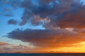 Fototapeta na wymiar Sunset light over Canary Islands . Awesome clouds over the Atlantic Ocean and island 