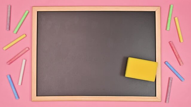 Sponge cleaning school blackboard. Copy space flat lay. Stop motion