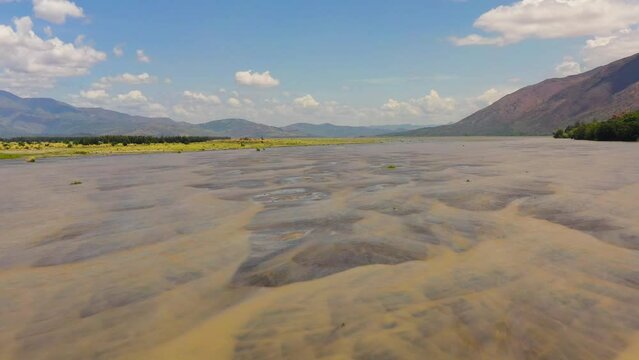 Top view of shallow river in the dry season in a mountain valley. Bucao river. Luzon, Philippines.