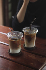 Closeup of Iced Caramel Macchiato at the coffee shop, Caramel Macchiato is a classic macchiato beverage. It consists of vanilla syrup, espresso, steamed milk, foam, and caramel drizzle
