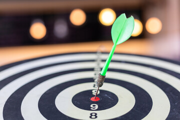 Dart arrow hitting in the target center of dartboard business targeting and winning goals business...
