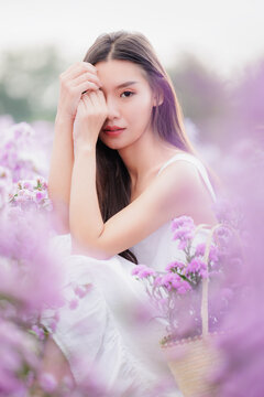 asian woman wearing white dress in the flowers garden. travel relax on vacation concept..