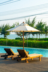 umbrella with bed pool around swimming pool with ocean sea background