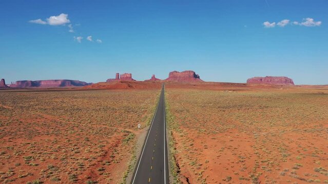 Drone shot of highway towards Monument Valley on a sunny day. Aerial view of US State Route 163 in Utah America.