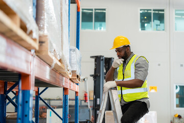 Portrait african black warehouse supervisor standing with digital tablet check stock in large warehouse distribution center with colleague worker in background. Business warehouse and logistic concept