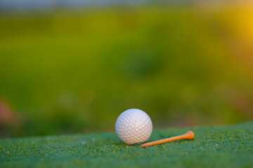 Golf ball on green in the evening golf course with sunshine in thailand.