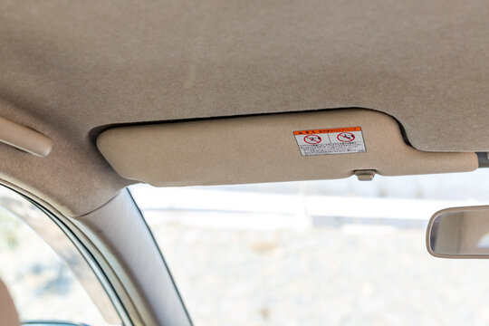 Sun visor in a vehicle with warning sign
