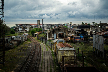 Abandoned train station with buildings in the background 