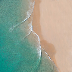 Aerial view of a beach with calm smooth waves on the Gold Coast