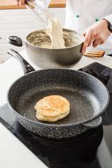chef making pancake in kitchen