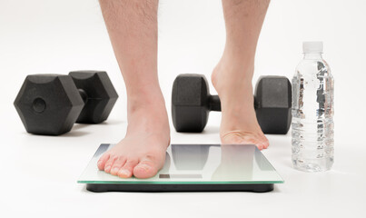 Fototapeta premium Asian middle-aged man's feet measuring weight