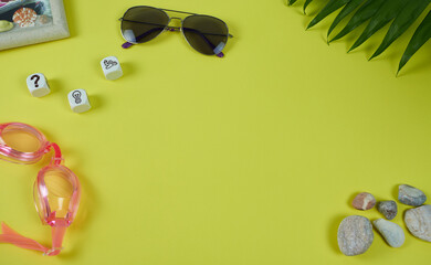 Glasses on yellow background with space for text. The concept is vacation planning for the family.