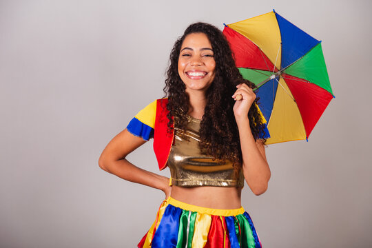 Beautiful black Brazilian woman, with frevo outfit, and umbrella, carnival.