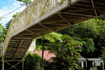 Low angle view of a pedestrian overpass at Kuranda Station in Cairns, with the Kuranda Scenic...