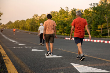 Fototapeta premium Senior people exercise walking at public park healthy lifestyle concept.