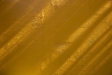 Sunlight Shadow On Abstract yellow Cement Wall Backgroun