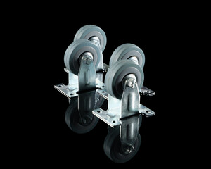 Rubber wheels in a metal frame on a black background with a reflection on the table.