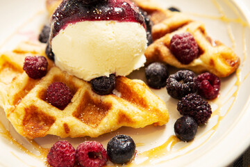 Ice cream on top of waffles and berries