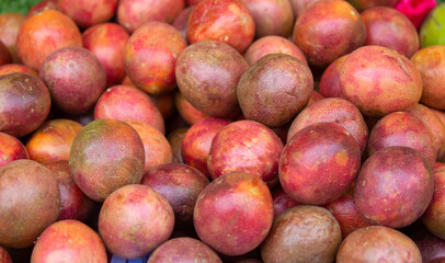 Passionfruit fruits close-up as a background. Bunch of tropical fruits harvesting.