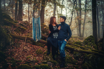 Naklejka na ściany i meble romantic couple in love in a misty forest, with a dream catcher.