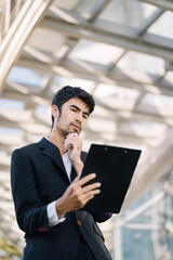 Fototapeta premium Businessman analysis graph company financial outside an office building..