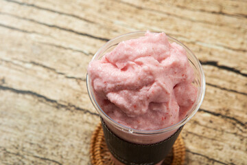 Blueberry milkshake in takeaway cup