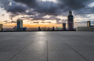 Empty square floor and modern city skyline with buildings at sunset in Ningbo, Zhejiang Province, China.