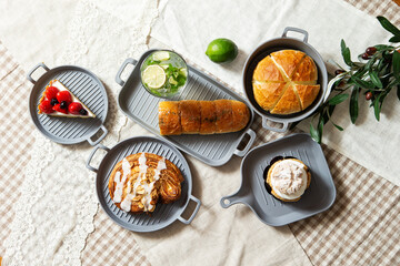 Lemonade, bread and slices of cake on the table
