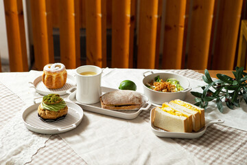 Coffee, sandwiches and bread on the table