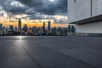 Empty square floor and modern city skyline with buildings at sunset in Ningbo, Zhejiang Province, China.  