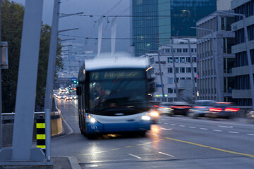 City highway hard bridge with blurry motion of bus and cars at City of Zürich on a cloudy autumn...