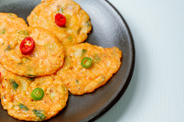 Kimchijeon, Korean Kimchi Pancake food : Slices of well-fermented kimchi mixed into a flour batter and pan- fried. Finely chopped pork, squid, and clam meat may be added to the batter as well.