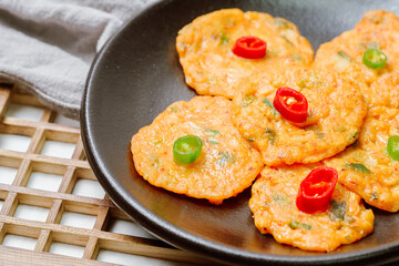 Kimchijeon, Korean Kimchi Pancake food : Slices of well-fermented kimchi mixed into a flour batter and pan- fried. Finely chopped pork, squid, and clam meat may be added to the batter as well.