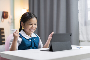 asian child smile learning on computer tablet or kid girl student fun to studying online class or...