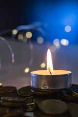 a candle on a dark background with illumination from a garland, the concept of a festive mood