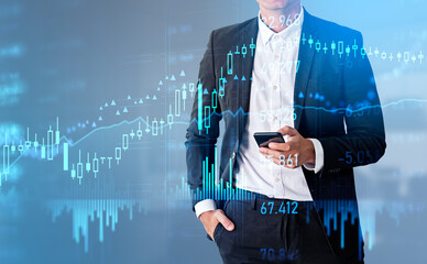 Businessman with phone in hand, stock market diagrams hologram