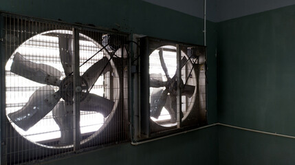Close-up of big industrial Exhaust fan in a factory. Ventilation of plant building. 